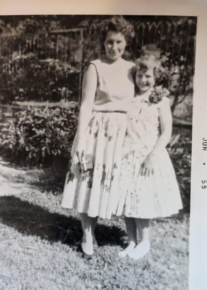 A woman and her daughter? posing in long skirts for the camera in 1955.